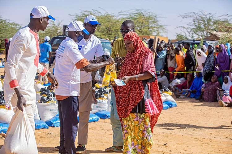 African volunteers distributing relief supplies during an NGO outreach